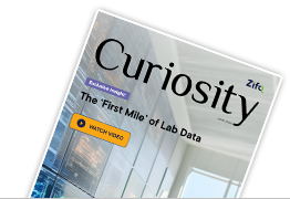 Magazine cover titled Curiosity with the subtitle 'The First Mile of Lab Data', tilted against a black background.